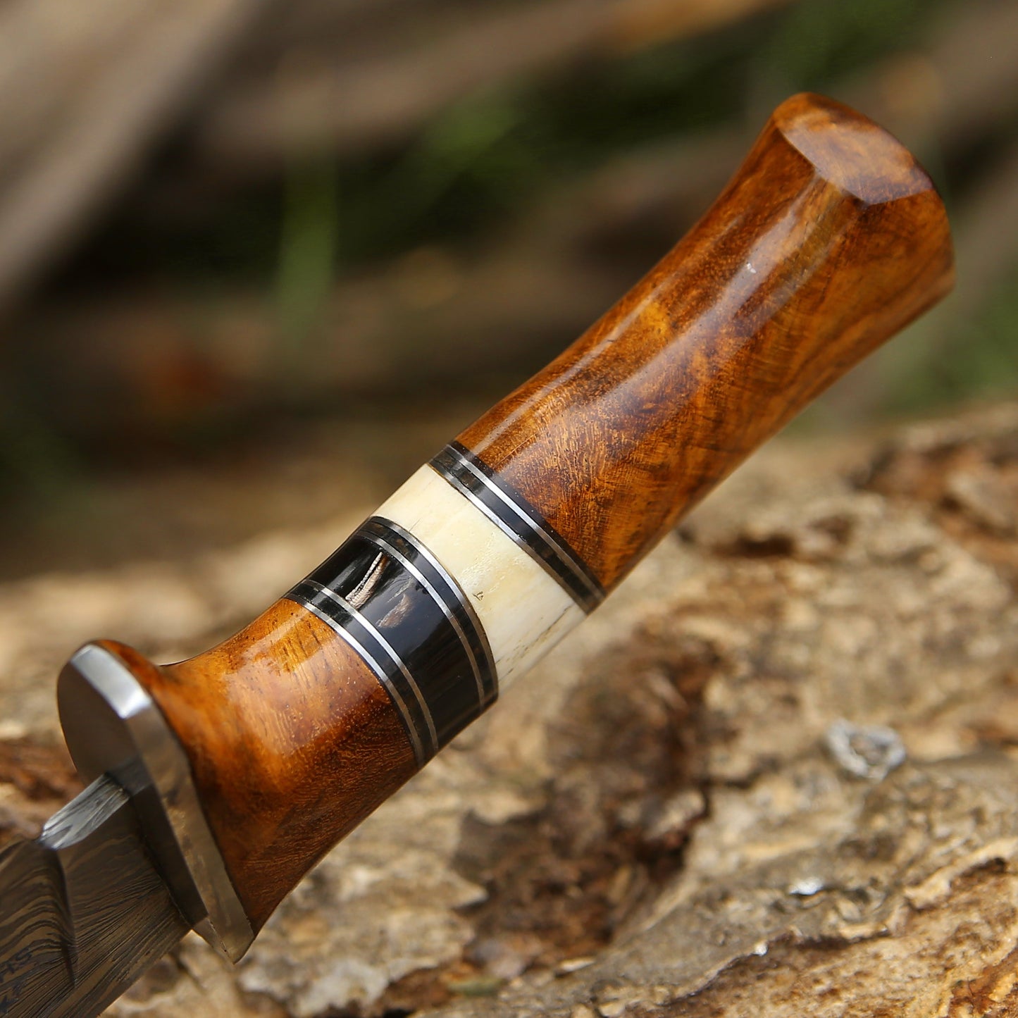 Wooden-handled knife with metal blade on a natural background